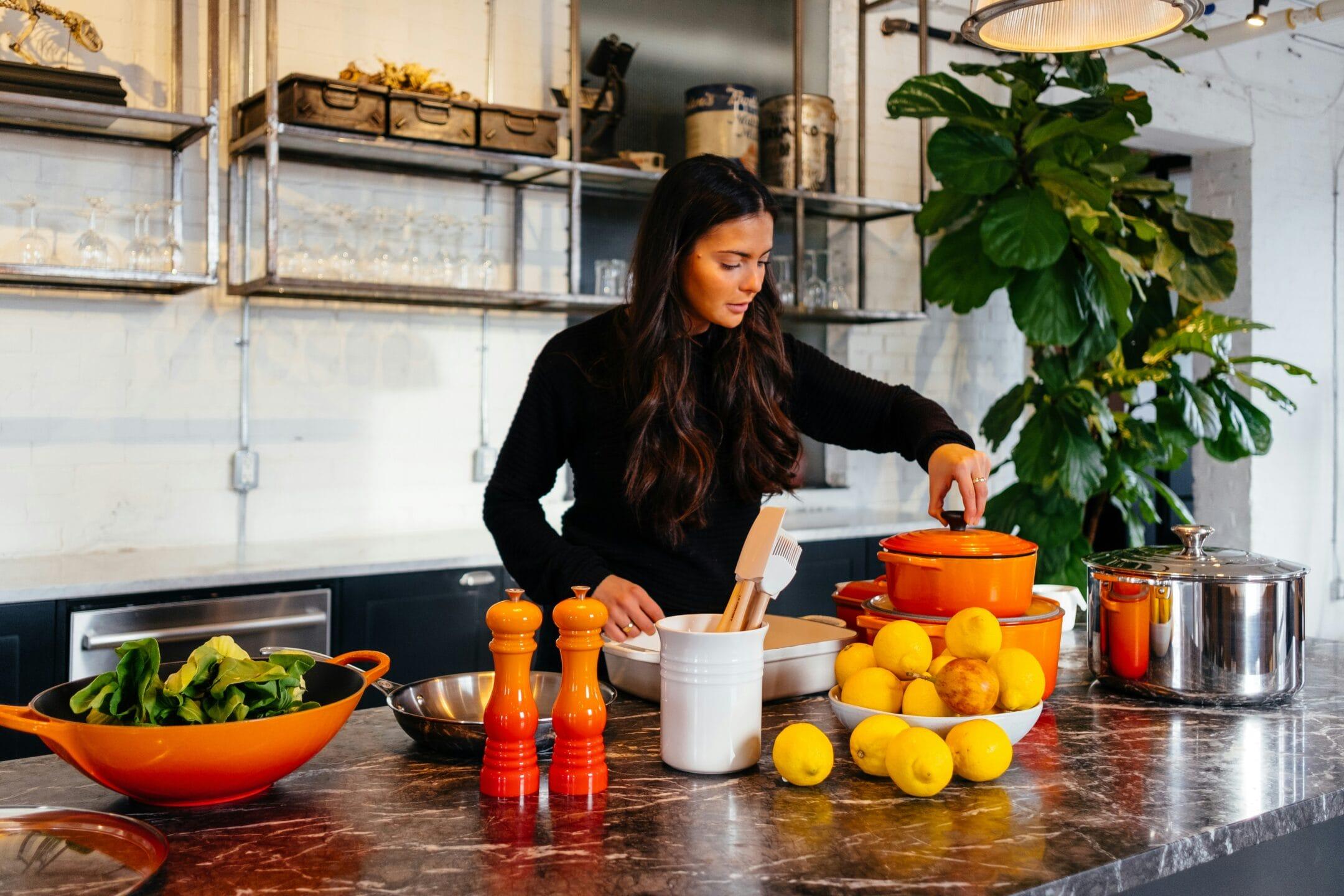 Woman Cooking in kitchen with food on the counter